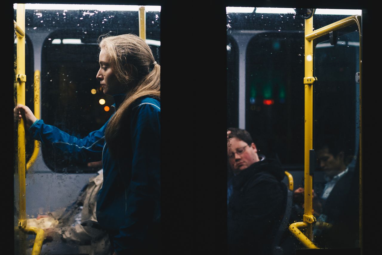 The Art of Drawing Readers In: Your attractive post title goes here A solitary woman stands in a dimly lit Dublin city bus during a nightly commute.